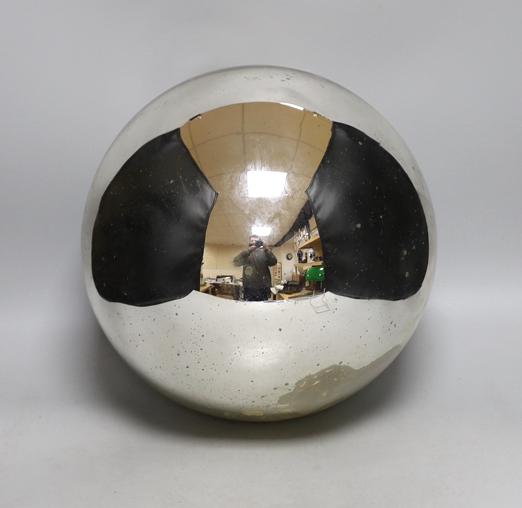 A large silver coloured witch’s ball, 31cm diam.